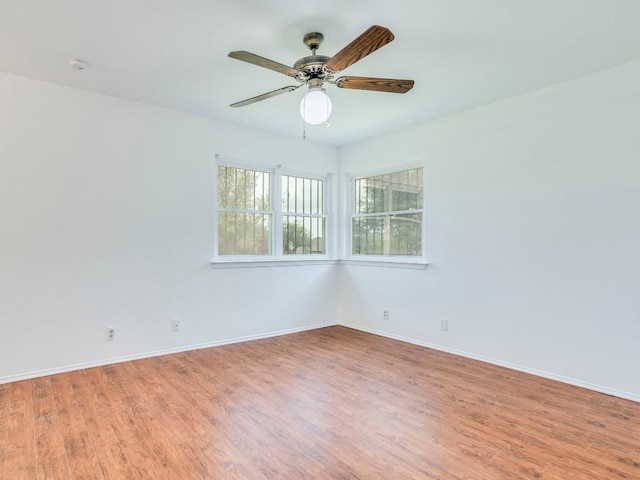 1705 W Braker Ln Unit A, Austin, TX 78758 - unfurnished room with baseboards, wood finished floors, and ceiling fan