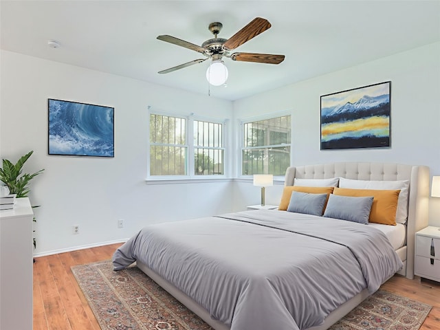 1705 W Braker Ln Unit A, Austin, TX 78758 - bedroom with light wood finished floors, baseboards, and a ceiling fan