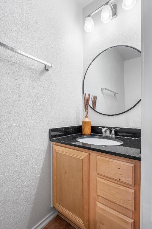 8936 Milton Lease Dr, Austin, TX 78747 - bathroom featuring vanity and a textured wall