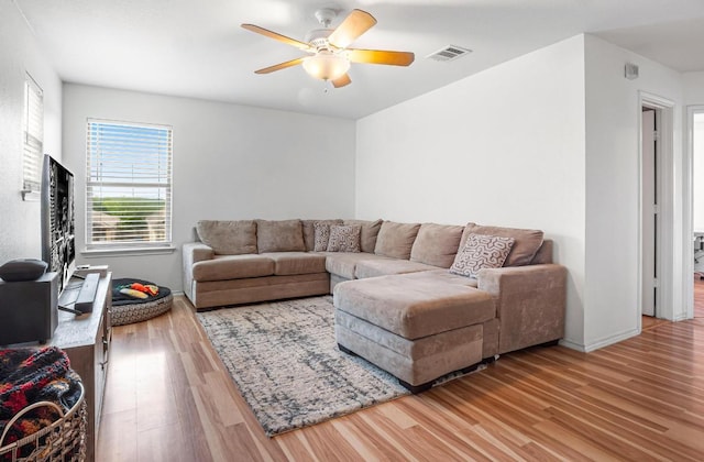 8936 Milton Lease Dr, Austin, TX 78747 - living area featuring wood finished floors, a ceiling fan, and baseboards