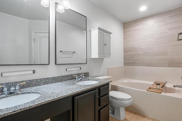 8936 Milton Lease Dr, Austin, TX 78747 - full bath with a tub to relax in, toilet, double vanity, and tile patterned flooring