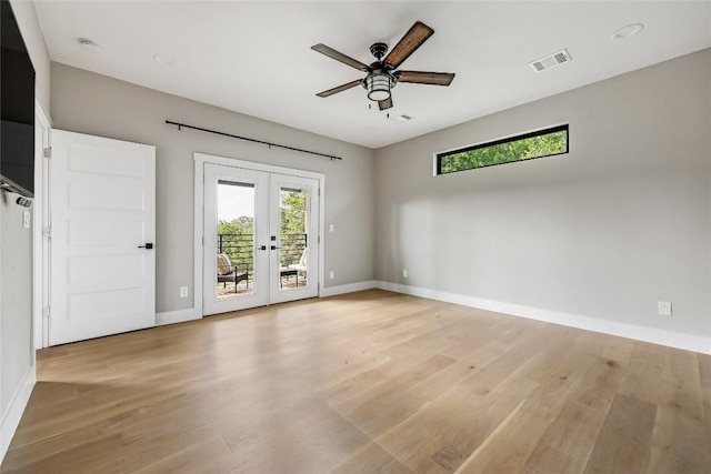18700 Venture Dr, Point Venture, TX 78645 - spare room featuring french doors, plenty of natural light, a ceiling fan, and light wood-type flooring