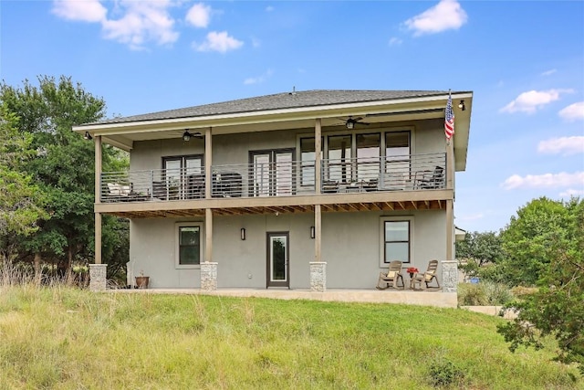 18700 Venture Dr, Point Venture, TX 78645 - back of house featuring a balcony, a ceiling fan, and stucco siding