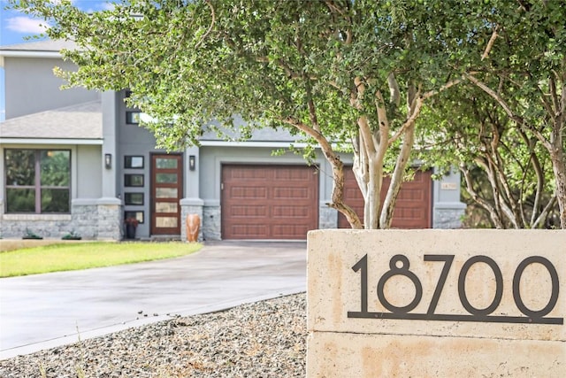 18700 Venture Dr, Point Venture, TX 78645 - view of front of home with driveway, an attached garage, stone siding, and stucco siding