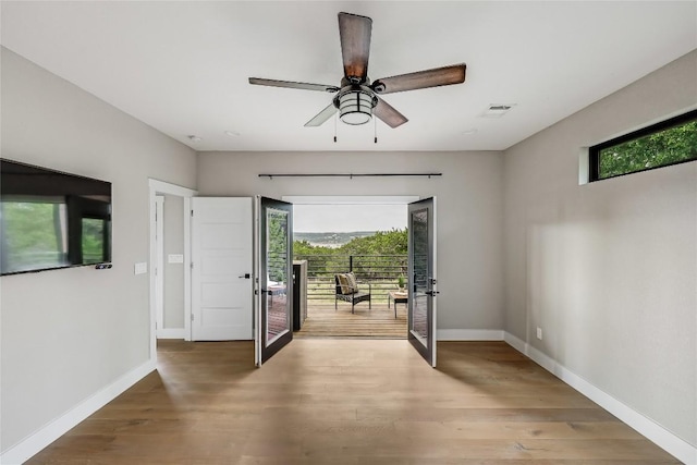 18700 Venture Dr, Point Venture, TX 78645 - foyer entrance with french doors, plenty of natural light, light wood-type flooring, and ceiling fan