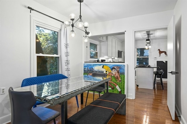 525 Barton Blvd, Austin, TX 78704 - dining room with wood finished floors, healthy amount of natural light, a chandelier, and baseboards