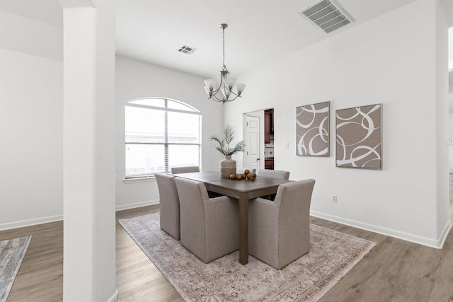 328 Palo Alto Way, Austin, TX 78732 - dining area featuring a chandelier, light wood-type flooring, and baseboards