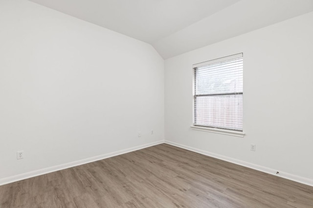 328 Palo Alto Way, Austin, TX 78732 - spare room featuring wood finished floors, lofted ceiling, and baseboards