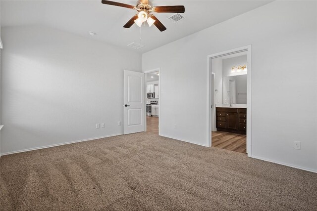 229 Reagor Dr, Taylor, TX 76574 - unfurnished bedroom with carpet flooring, ensuite bathroom, baseboards, vaulted ceiling, and ceiling fan