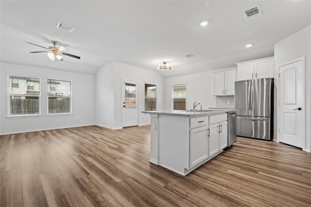 229 Reagor Dr, Taylor, TX 76574 - kitchen featuring appliances with stainless steel finishes, healthy amount of natural light, a sink, wood finished floors, and recessed lighting
