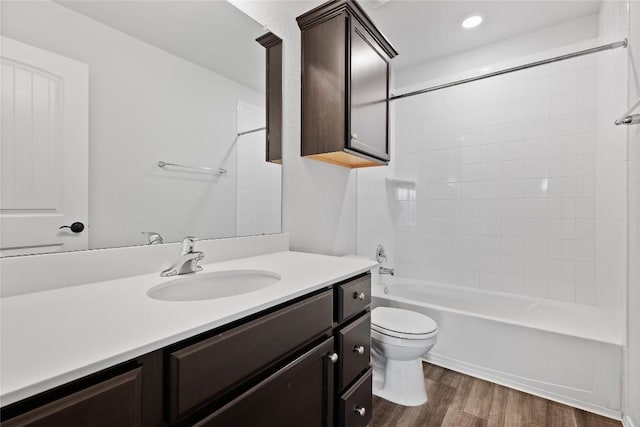229 Reagor Dr, Taylor, TX 76574 - full bathroom with wood finished floors, vanity, toilet, and shower / tub combination