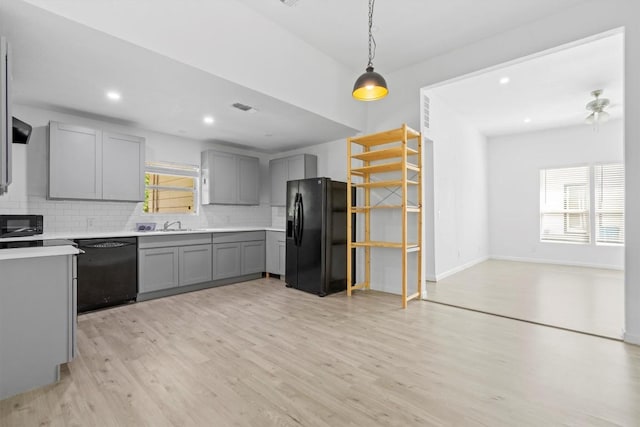 204 E Brenham St, Elgin, TX 78621 - kitchen featuring black appliances, gray cabinetry, decorative backsplash, healthy amount of natural light, and recessed lighting