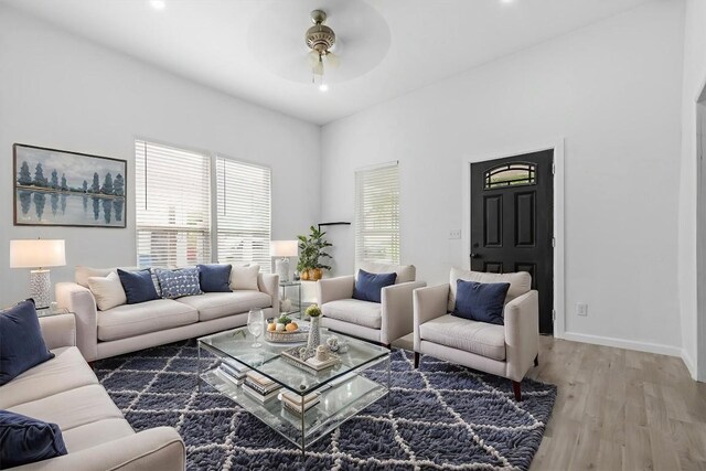 204 E Brenham St, Elgin, TX 78621 - living room featuring wood finished floors, a ceiling fan, and baseboards