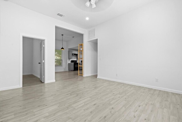 204 E Brenham St, Elgin, TX 78621 - unfurnished living room with ceiling fan, light wood-type flooring, and baseboards