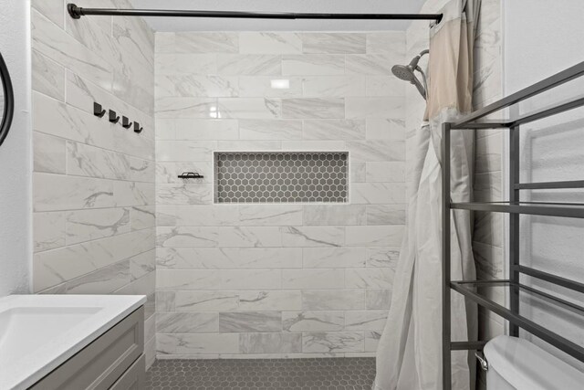 204 E Brenham St, Elgin, TX 78621 - bathroom featuring a tile shower, toilet, and vanity
