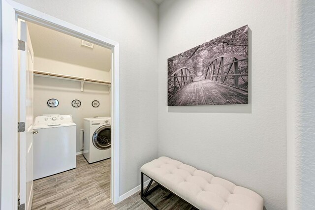 133 Free Stone Dr, Georgetown, TX 78628 - laundry area with washing machine and dryer, wood finished floors, and baseboards