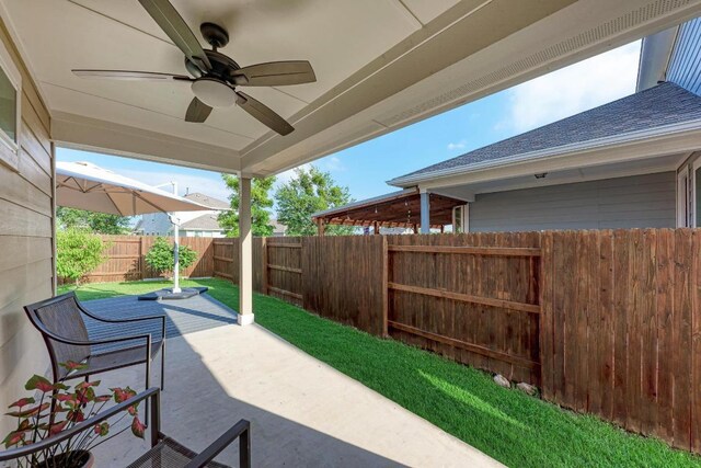 133 Free Stone Dr, Georgetown, TX 78628 - fenced backyard featuring a ceiling fan and a patio