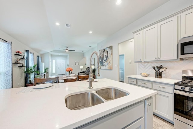 133 Free Stone Dr, Georgetown, TX 78628 - kitchen with appliances with stainless steel finishes, a sink, light countertops, ceiling fan, and open floor plan