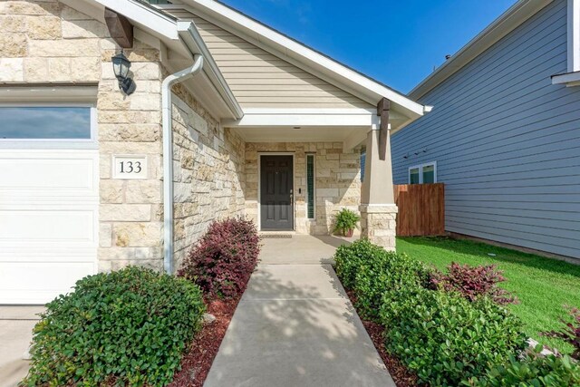 133 Free Stone Dr, Georgetown, TX 78628 - property entrance with stone siding and an attached garage