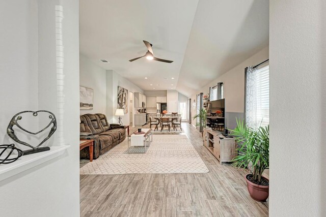 133 Free Stone Dr, Georgetown, TX 78628 - living room featuring a ceiling fan, light wood-style flooring, and vaulted ceiling
