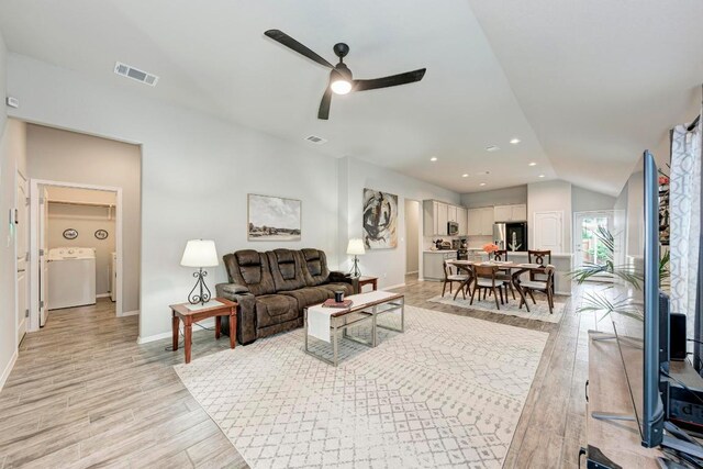 133 Free Stone Dr, Georgetown, TX 78628 - living area with washer / clothes dryer, light wood-type flooring, baseboards, a ceiling fan, and vaulted ceiling