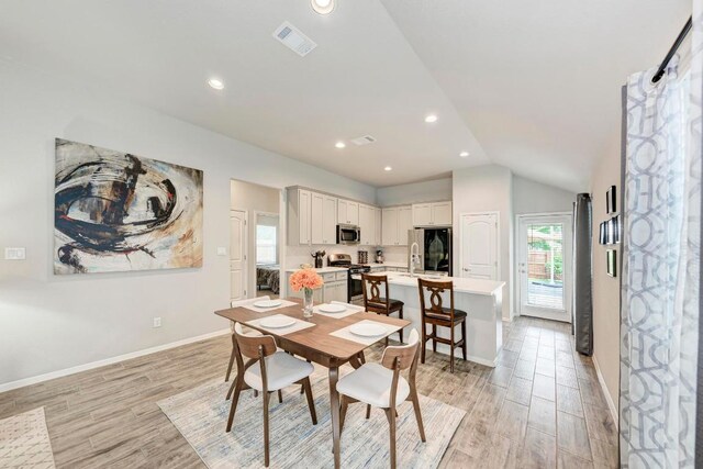 133 Free Stone Dr, Georgetown, TX 78628 - dining room with light wood finished floors, lofted ceiling, baseboards, and recessed lighting