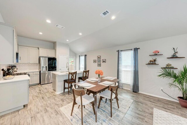 133 Free Stone Dr, Georgetown, TX 78628 - dining room featuring healthy amount of natural light, light wood-style flooring, lofted ceiling, baseboards, and recessed lighting
