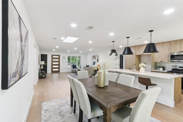 2322 Westoak Dr, Austin, TX 78704 - dining space with light wood-type flooring, recessed lighting, and a skylight
