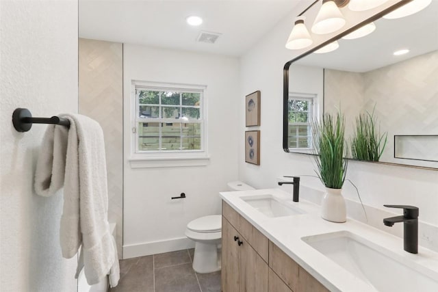 2322 Westoak Dr, Austin, TX 78704 - full bathroom with healthy amount of natural light, double vanity, tile patterned flooring, and recessed lighting