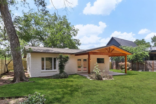 2322 Westoak Dr, Austin, TX 78704 - rear view of house featuring french doors, brick siding, a fenced backyard, and a patio area