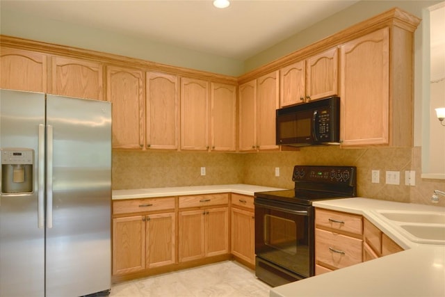 115 Dickens Cir, Georgetown, TX 78633 - kitchen with black appliances, light brown cabinets, light countertops, and tasteful backsplash