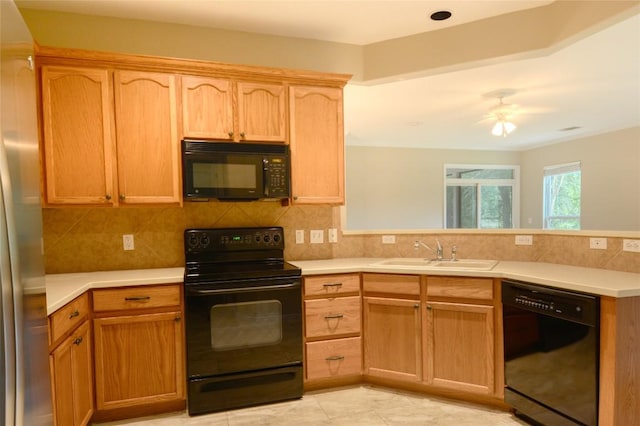 115 Dickens Cir, Georgetown, TX 78633 - kitchen featuring black appliances, a peninsula, light countertops, and decorative backsplash