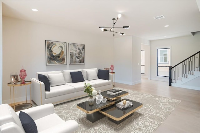 1201 Friends Cv, Round Rock, TX 78681 - living room with a chandelier, light wood finished floors, stairs, and recessed lighting