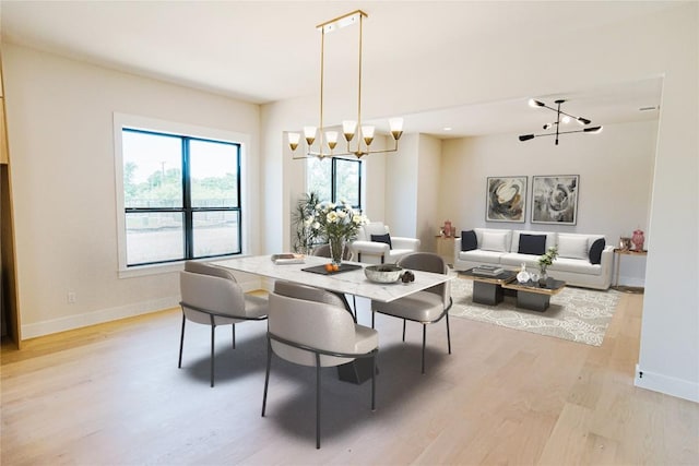 1201 Friends Cv, Round Rock, TX 78681 - dining room featuring a chandelier, light wood-style floors, and rail lighting
