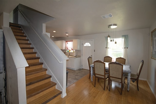 2723 Moonmist Cv, Round Rock, TX 78665 - dining space with stairway, light wood finished floors, and recessed lighting