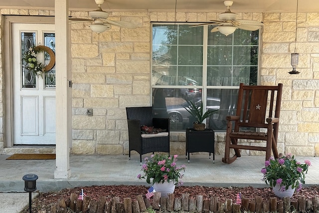 2723 Moonmist Cv, Round Rock, TX 78665 - view of exterior entry featuring ceiling fan and stone siding