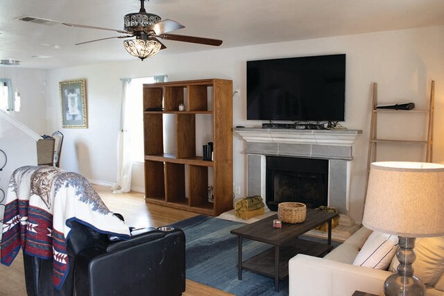 2723 Moonmist Cv, Round Rock, TX 78665 - living room with ceiling fan, wood finished floors, and a fireplace