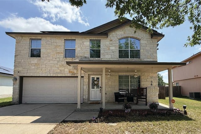 2723 Moonmist Cv, Round Rock, TX 78665 - view of front of home featuring ceiling fan, stone siding, concrete driveway, and a garage