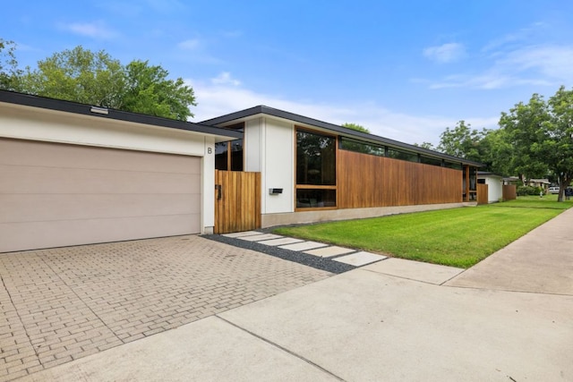 6506 Arroyo Seco, Austin, TX 78757 - view of front of home featuring decorative driveway and an attached garage