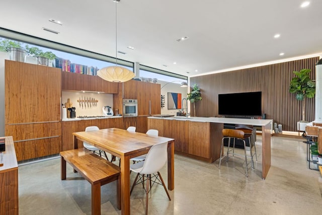 6506 Arroyo Seco, Austin, TX 78757 - dining area featuring finished concrete flooring, recessed lighting, and an office area