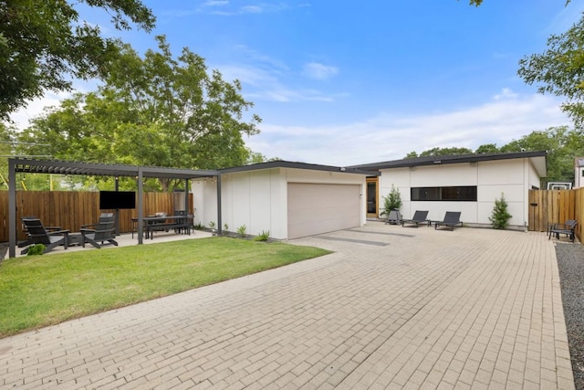 6506 Arroyo Seco, Austin, TX 78757 - view of front of home featuring an attached garage, a patio, and driveway