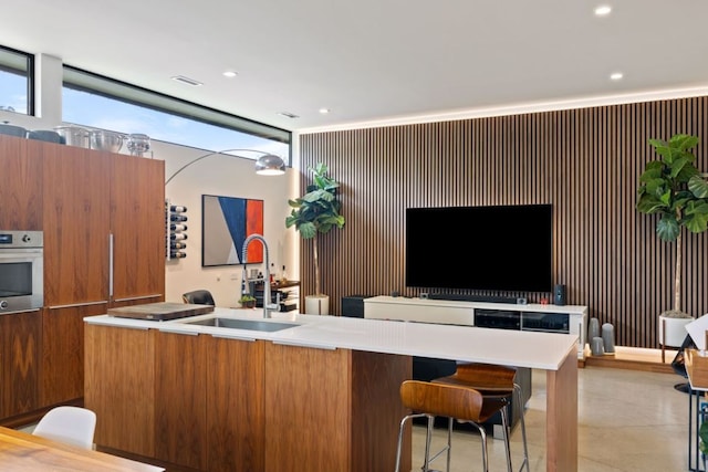 6506 Arroyo Seco, Austin, TX 78757 - kitchen with a sink, oven, modern cabinets, a kitchen island with sink, and recessed lighting