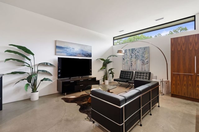 6506 Arroyo Seco, Austin, TX 78757 - living room featuring concrete flooring and floor to ceiling windows