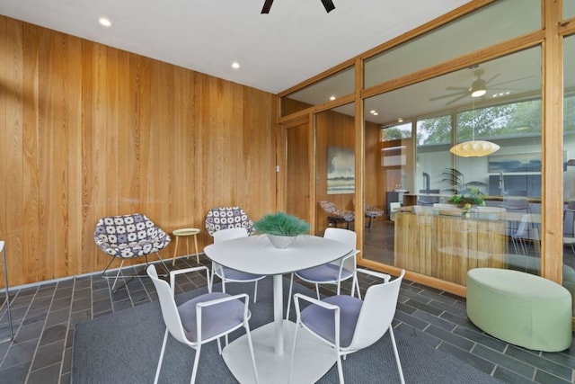 6506 Arroyo Seco, Austin, TX 78757 - dining space with ceiling fan, wood walls, and recessed lighting