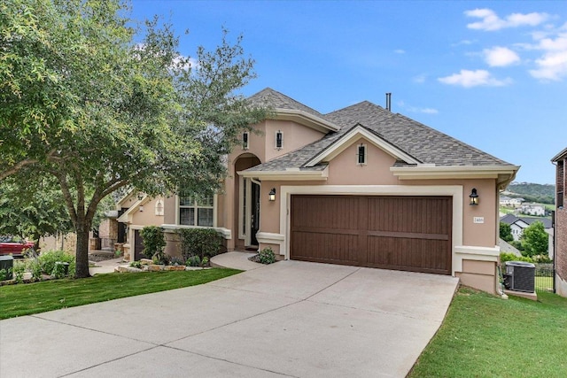 2416 Montello Ct, Leander, TX 78641 - view of front of home with stucco siding, a garage, driveway, and a front yard