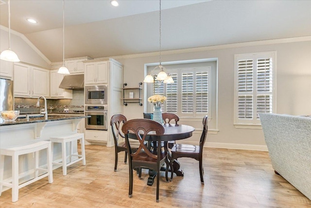 2416 Montello Ct, Leander, TX 78641 - dining room with a chandelier, light wood-style flooring, crown molding, recessed lighting, and vaulted ceiling