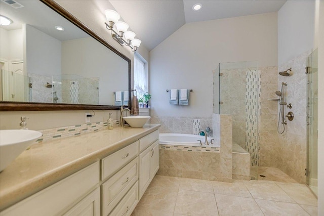 2416 Montello Ct, Leander, TX 78641 - full bath featuring double vanity, a tile shower, a bath, vaulted ceiling, and tile patterned floors