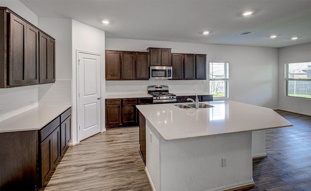 102 George Kimble Cv, Bastrop, TX 78602 - kitchen with appliances with stainless steel finishes, a sink, plenty of natural light, light wood-style flooring, and recessed lighting