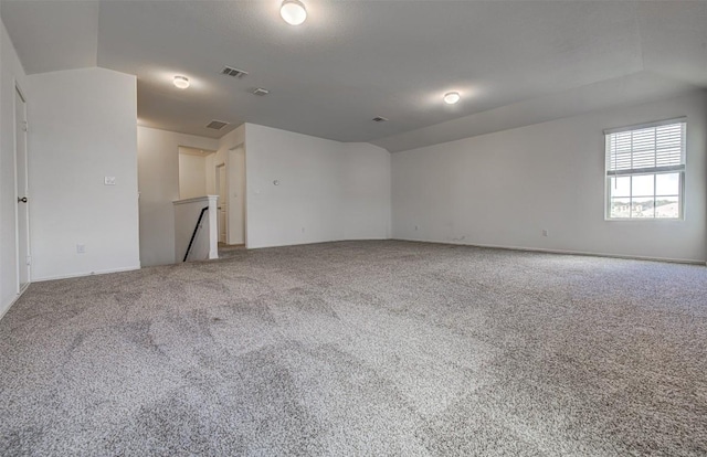 102 George Kimble Cv, Bastrop, TX 78602 - unfurnished room with carpet flooring, baseboards, and vaulted ceiling
