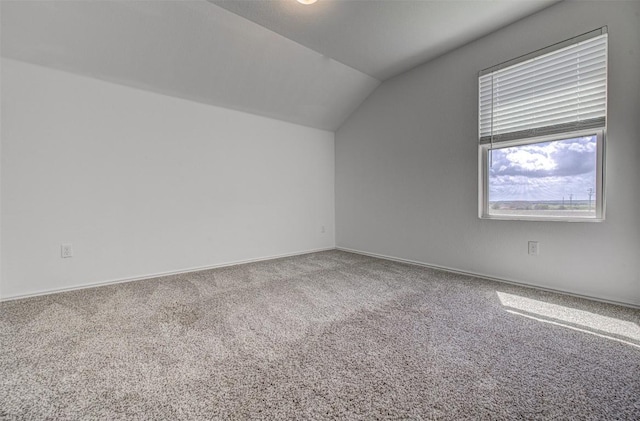 102 George Kimble Cv, Bastrop, TX 78602 - additional living space with lofted ceiling, carpet flooring, and baseboards